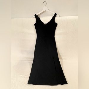 Black dress with left slit. Can be dressed up for cocktail or down for casual.